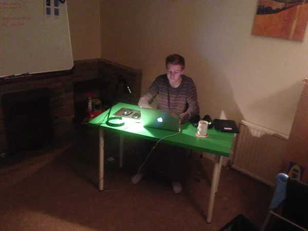 Late night at a home desk, MacBook glow